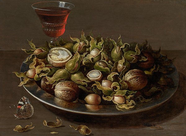 Still life of a pewter plate of hazelnuts and walnuts, a facon-de-Venise glass of red wine and a Red Admiral butterfly (Vanessa atalanta) on a table top