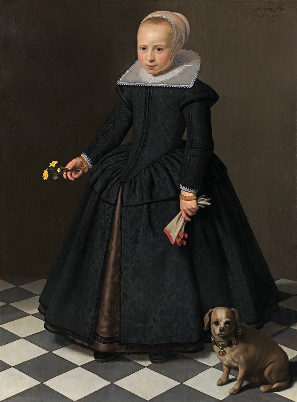 Young girl holding flowers, a dog beside her