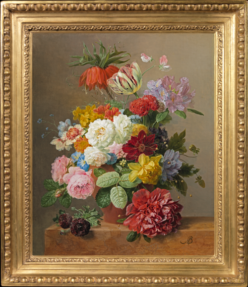 Still life with roses, peonies, tulips and other flowers in a vase on a marble ledge